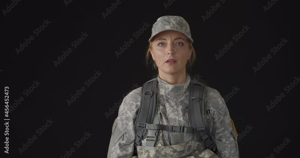 Saluting female soldier on black background Saluting female soldier on black background