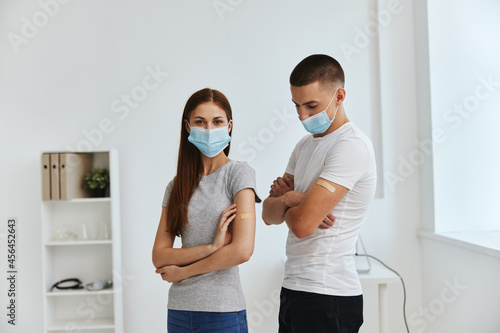 man and woman at the reception at the hospital with bactericidal layers on the shoulders covid passport