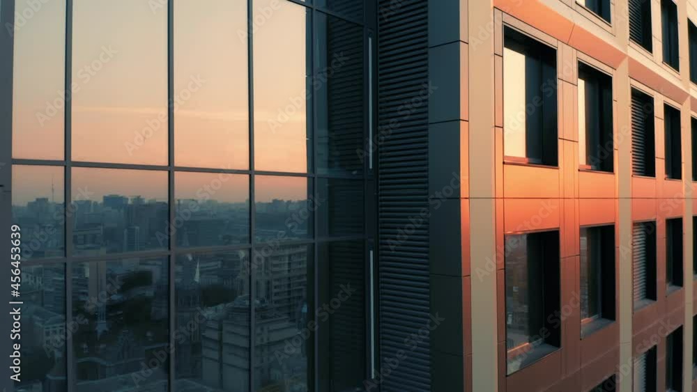 Aerial side view of a newly built skyscraper in downtown at sunset. Close-up Aerial side view of a newly built skyscraper in downtown at sunset. Close-up