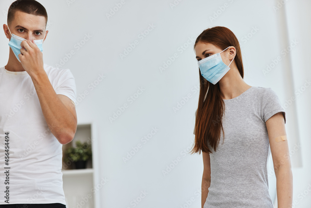 young couple wearing medical masks covid-19 vaccination passport