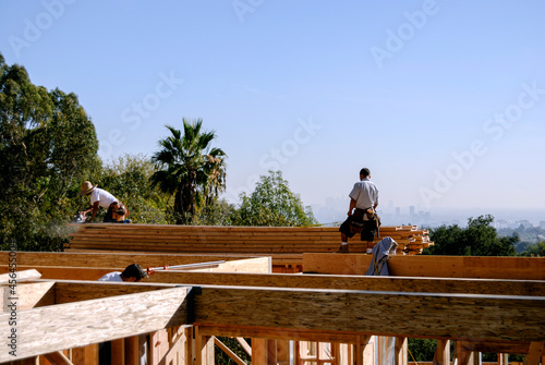 Framing carpenters working high-up on a second story deck