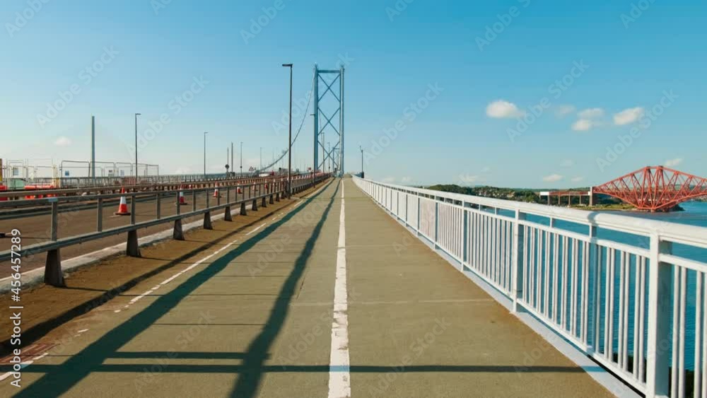 Walking along the Forth Road Bridge, a suspension bridge which spans the Firth of Forth, connecting Edinburgh to Fife in Scotland Walking along the Forth Road Bridge, a suspension bridge which spans the Firth of Forth, connecting Edinburgh to Fife in Scotland
