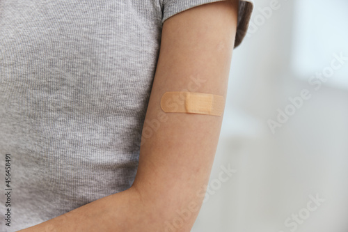 adhesive plaster on the shoulder female hand immunity vaccination health safety immunization