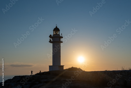 People walk down the street towards the Cap de Barbarie Lighthouse in Formentera in the summer of 2021.