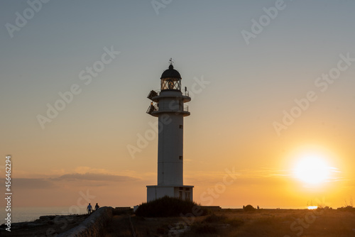 People walk down the street towards the Cap de Barbarie Lighthouse in Formentera in the summer of 2021. © martinscphoto