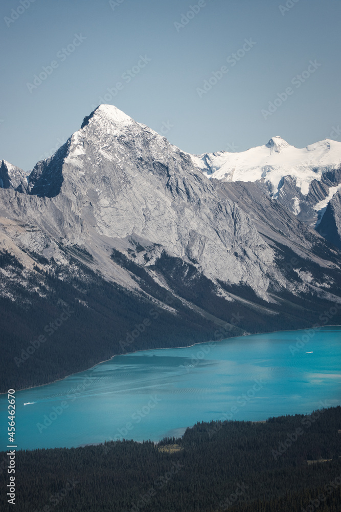 Mountain lake in front of majestic mountain with snow covered peak in Jasper National Park, Canada