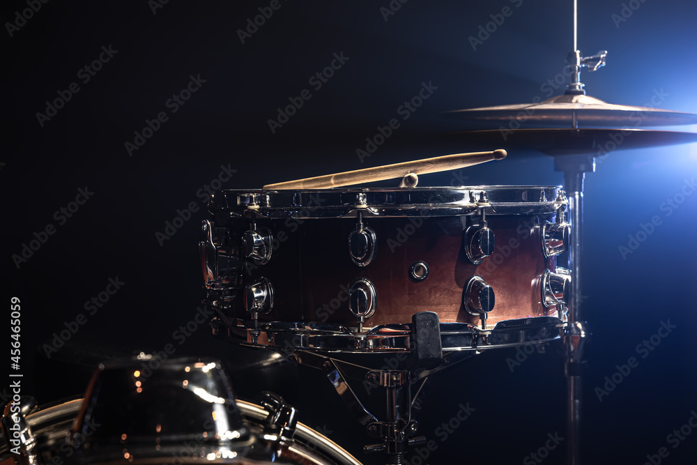 Fototapeta premium Part of a drum kit, snare drum on a dark background.