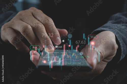 Trader using mobile phone checking stock market report. Business, finance and investment, forex trading, currency exchange, economic growth, stock market analysis concept