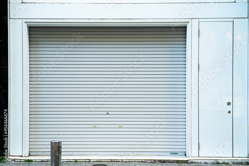 white shutter door of closed shop
