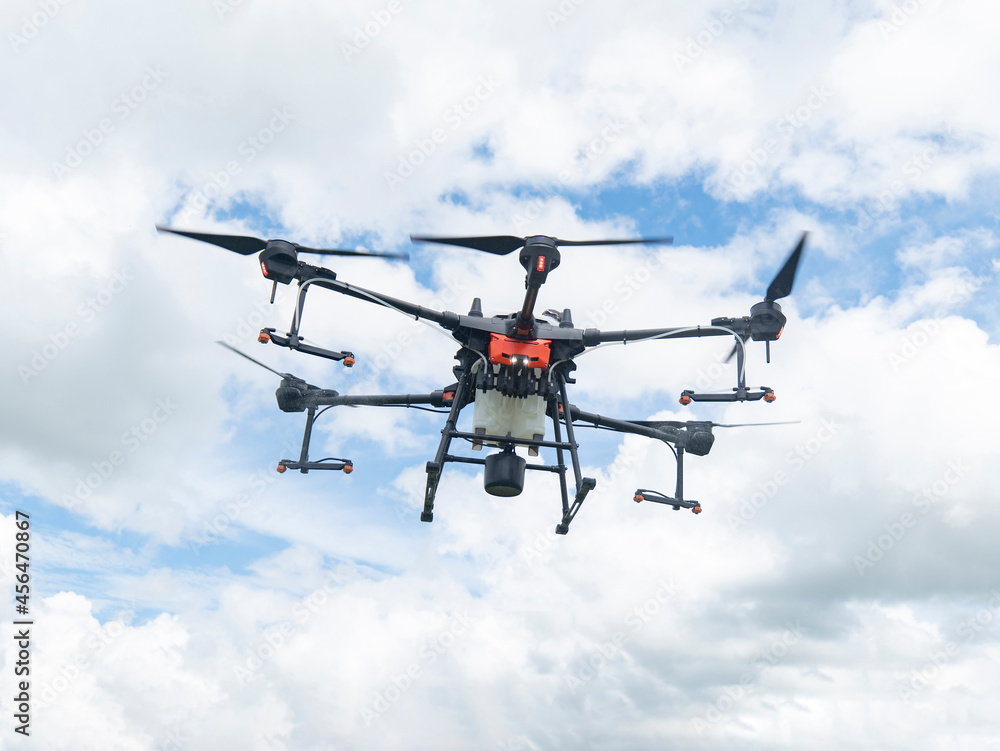 Fototapeta premium Agricultural drones make flights to prepare to spray rice fields. Agricultural technology smart farm concept.
