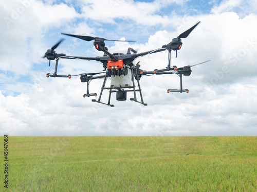 Fototapeta Naklejka Na Ścianę i Meble -  Agricultural drones make flights to prepare to spray rice fields. Agricultural technology smart farm concept.