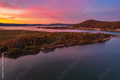 Aerial sunset waterscape over the bay with high cloud