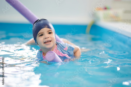 Child swimming on floating pipe