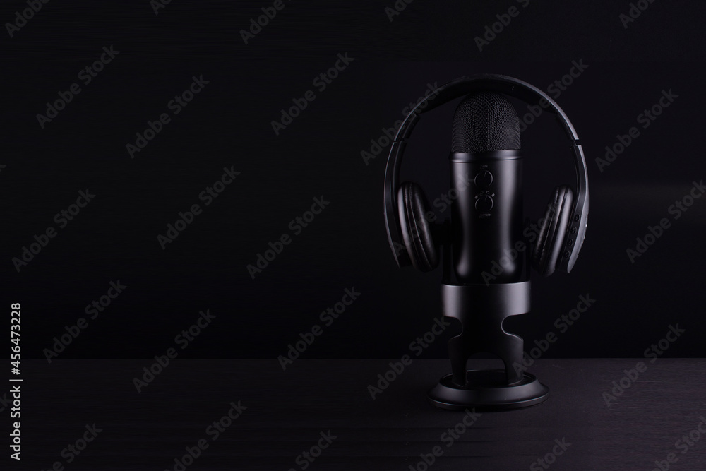 headphones and microphone on black background headphones and microphone on black background