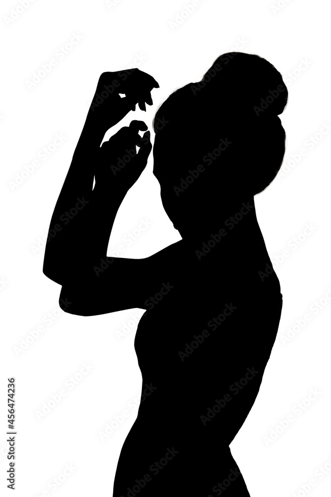 silhouette of a slender elegant woman with beautifully raised hands.
