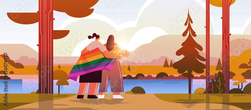 two girls holding lgbt rainbow flag gay lesbian love parade pride festival transgender love concept