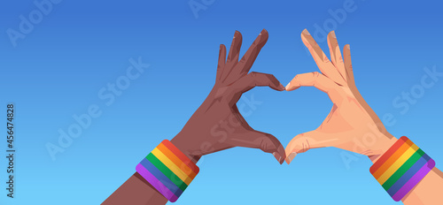 mix race human hands gesture in heart shape lgbt rainbow flag gay lesbian love parade pride festival transgender love