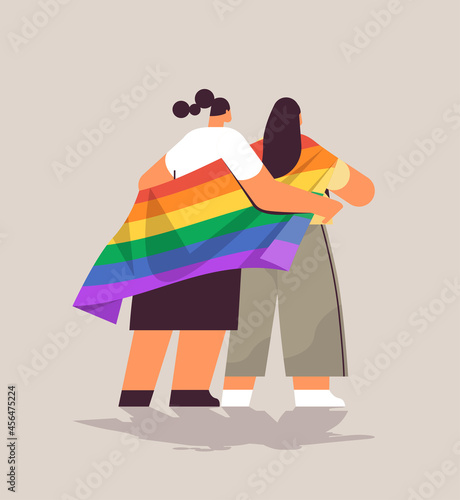two girls holding lgbt rainbow flag gay lesbian love parade pride festival transgender love concept full length