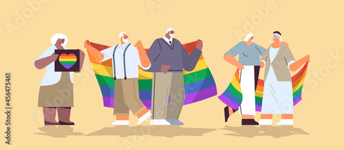 mix race senior people group holding lgbt rainbow flag gay lesbian love parade pride festival transgender love concept