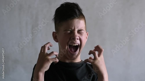 Screaming teenage boy on a dark background
