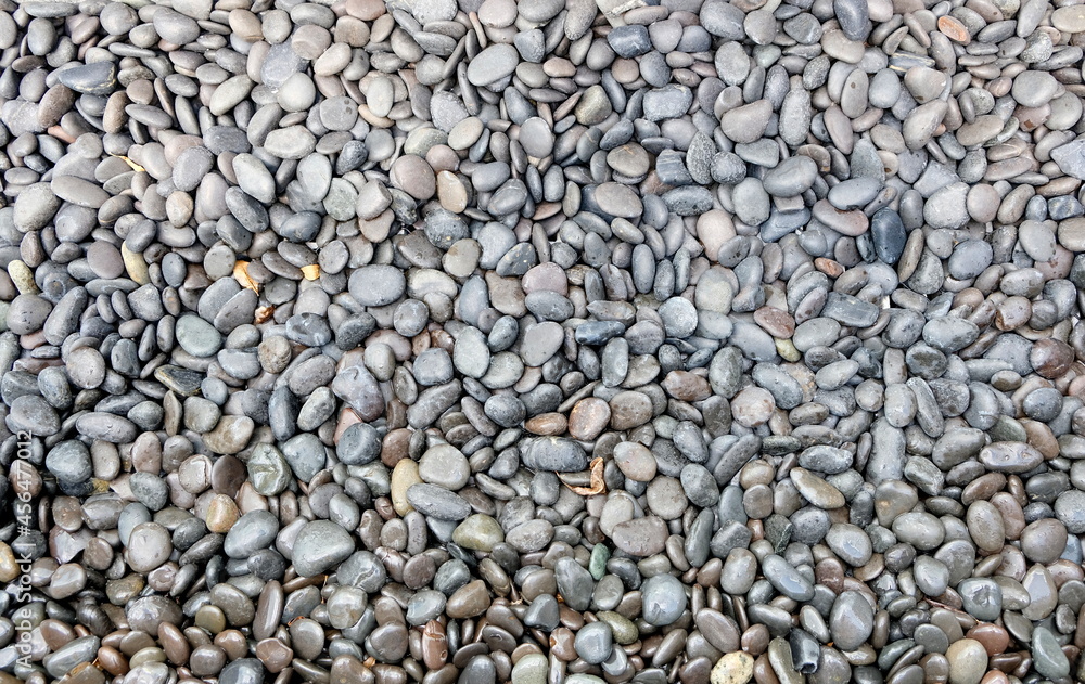 Background of decorative light-grey small polished rocks Background of decorative light-grey small polished rocks