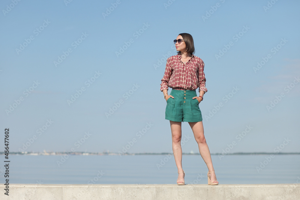 young woman in summer clothes by the sea young woman in summer clothes by the sea