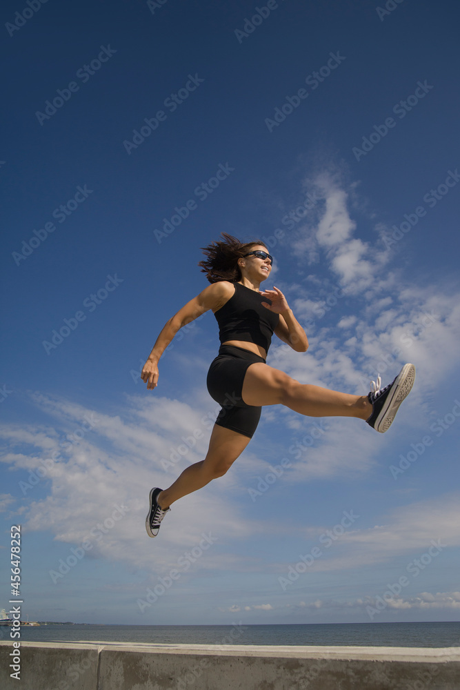 athletic young woman exercising outdoors