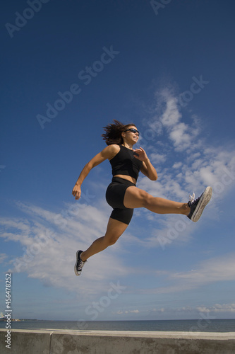 athletic young woman exercising outdoors