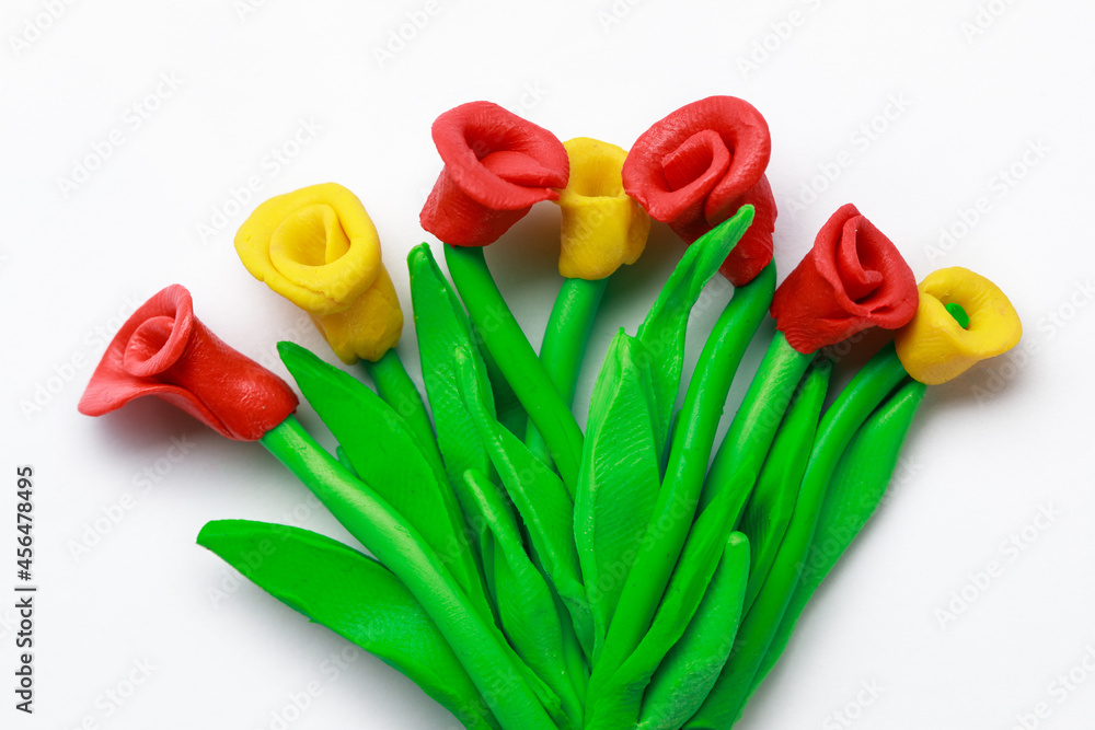Flowers made from plasticine, white background Flowers made from plasticine, white background