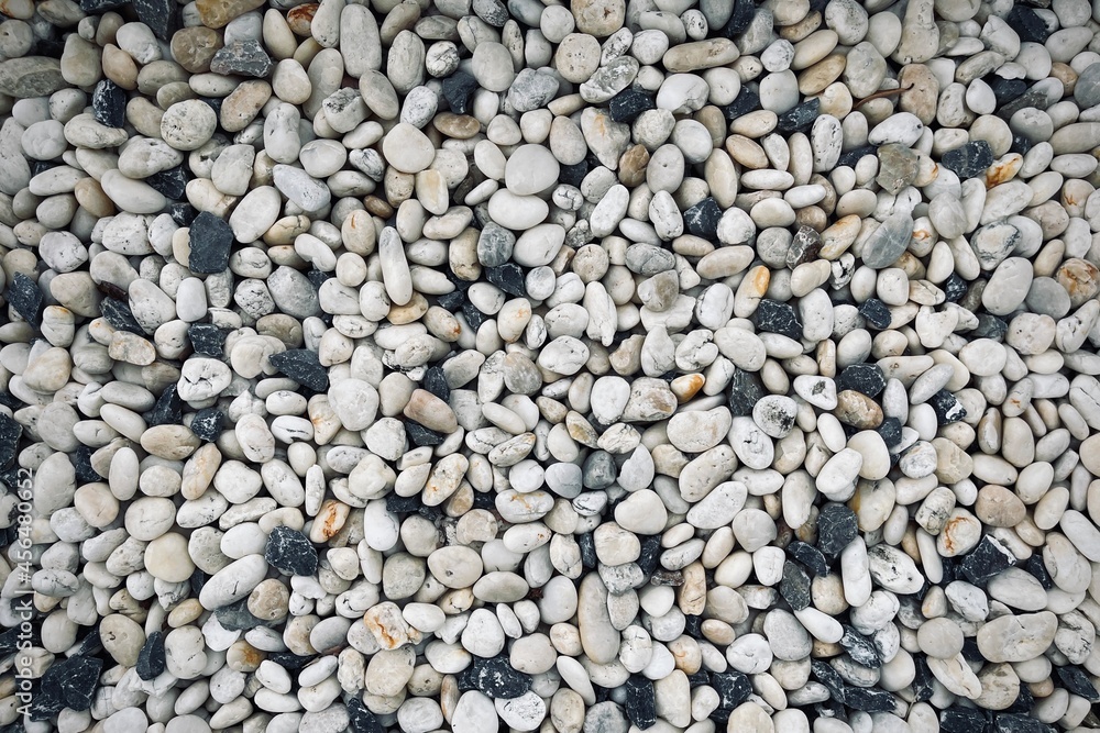 Smooth round pebbles texture background. Pebble sea beach close-up, dark wet pebble and gray dry pebble. Smooth round pebbles texture background. Pebble sea beach close-up, dark wet pebble and gray dry pebble.