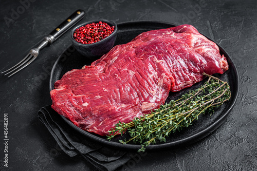 Fototapete Flank or flap raw beef steak on plate with thyme