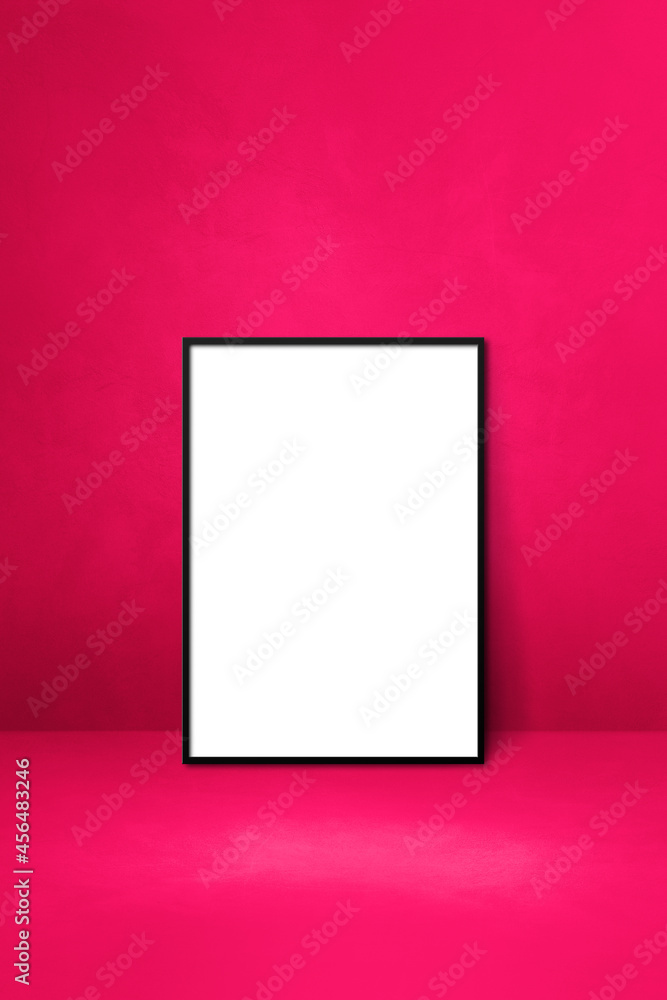 Black picture frame leaning on a pink wall Black picture frame leaning on a pink wall