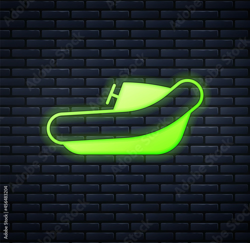 Glowing neon Inflatable boat with outboard motor icon isolated on brick wall background. Vector