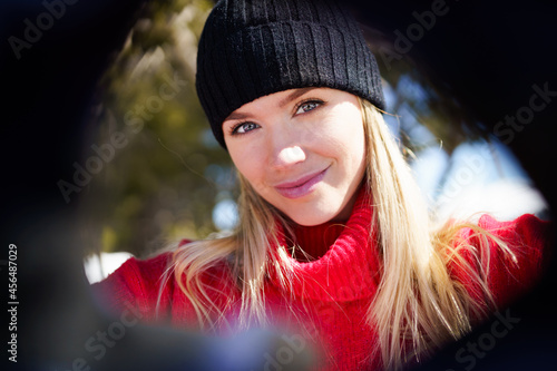 Canvastavla Young blonde woman taking a selfie in a snowy mountain forest in winter