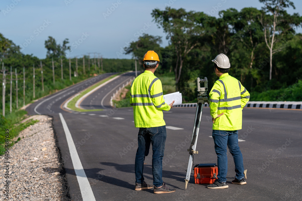 Asian surveyor engineers worker making measuring with theodolite instrument equipment during construction road works, Civil Engineers, Surveyor equipment.