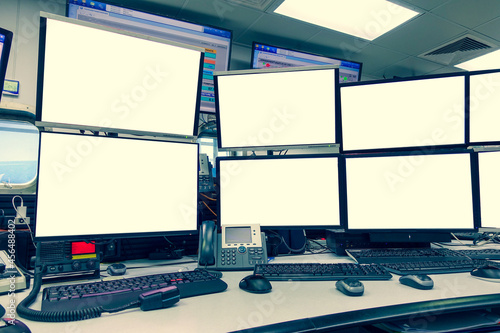 group of blank monitors and screen on security desk or control room for monitor process or stock data trading © Goodvibes Photo