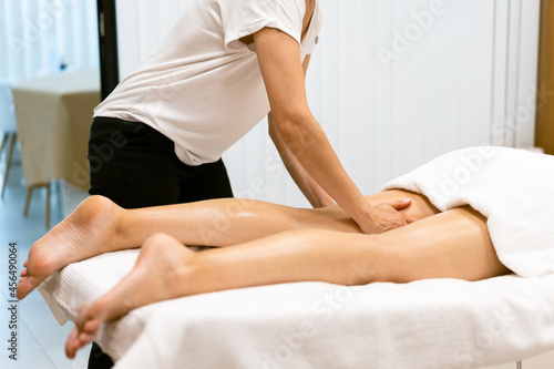 Middle-aged woman having a leg massage in a beauty salon.