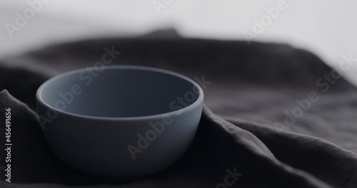 empty blue ceramic bowl on linen cloth