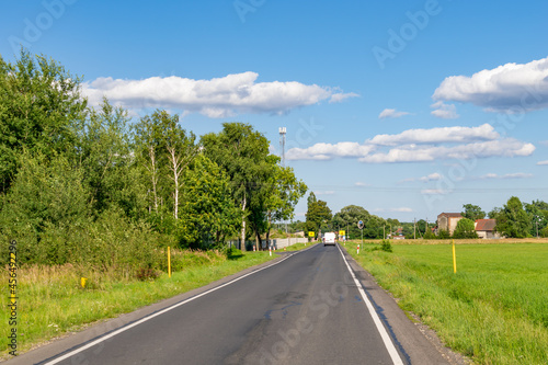 road on a beautiful sunny day against the backdrop of a blue sky