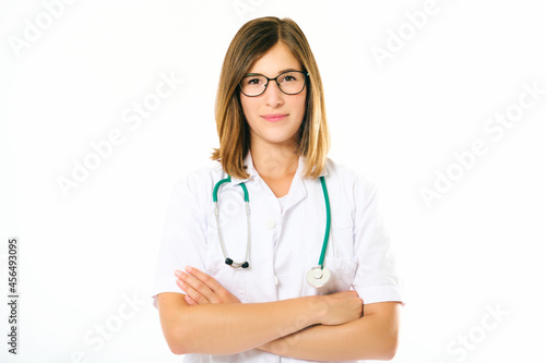 Studio portrait of young female doctor posing on white background