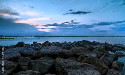 Photo of the sea at night. Sea at night, shades of blue, stones in the foreground, sea, night, beautiful relaxing landscape.