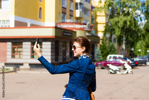 Happy woman take a selfie photo in the city.