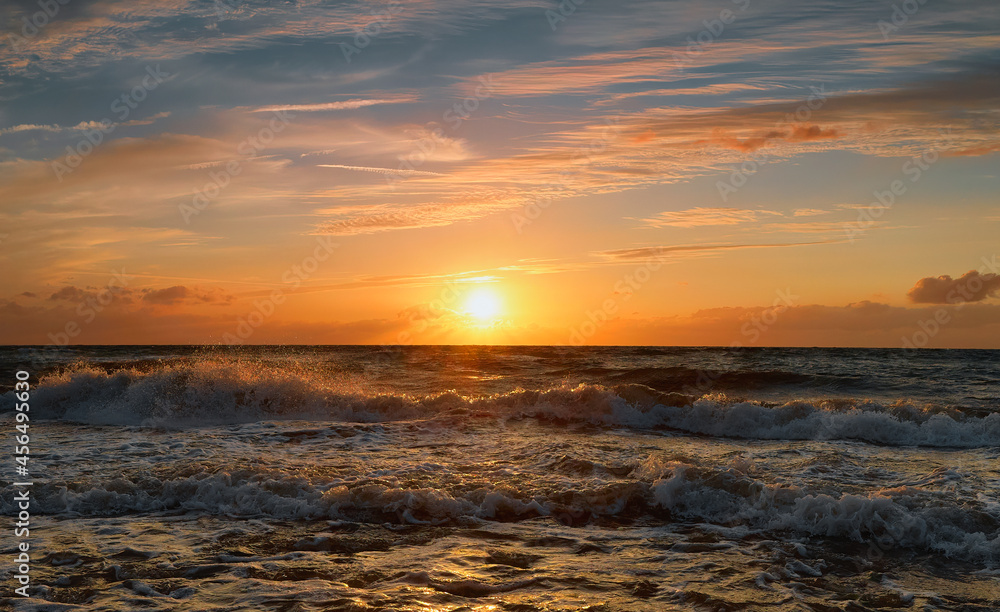 Obraz premium Photo of the sea evening landscape. Evening sea, sunset, dunes and hills, beautiful coast and waves.