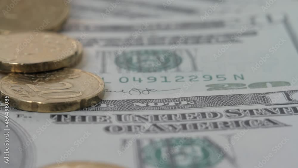 Euro cents fall on dollars on the table. Macro view Euro cents fall on dollars on the table. Macro view
