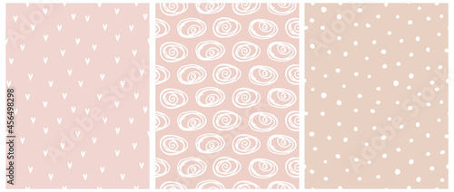 Cute Abstract Seamless Vector Patterns with White Irregular Brush Swirls,Dots and Hearts Isolated on a Pastel Pink and Blush Beige Background. Infantile Style Geometric Print. Abstract Doodle Pattern.