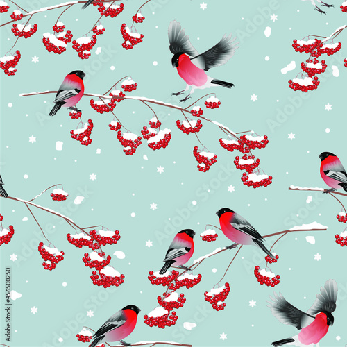 Bright flock of bullfinches on snowy branches with red berries. Seamless pattern on a blue background with elements and contours of trees. Vector for fabrics, wallpapers, notebook covers