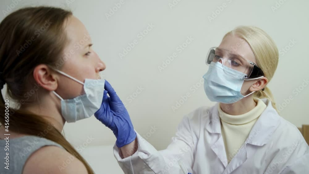 The nurse takes a sample from the patient's nose using a special stick. Coronavirus test. An epidemic of a dangerous virus. 4K UHD The nurse takes a sample from the patient's nose using a special stick. Coronavirus test. An epidemic of a dangerous virus. 4K UHD