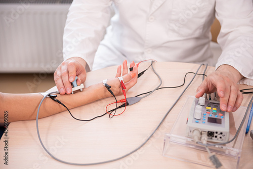 Patient nerves testing using electromyography at medical center photo