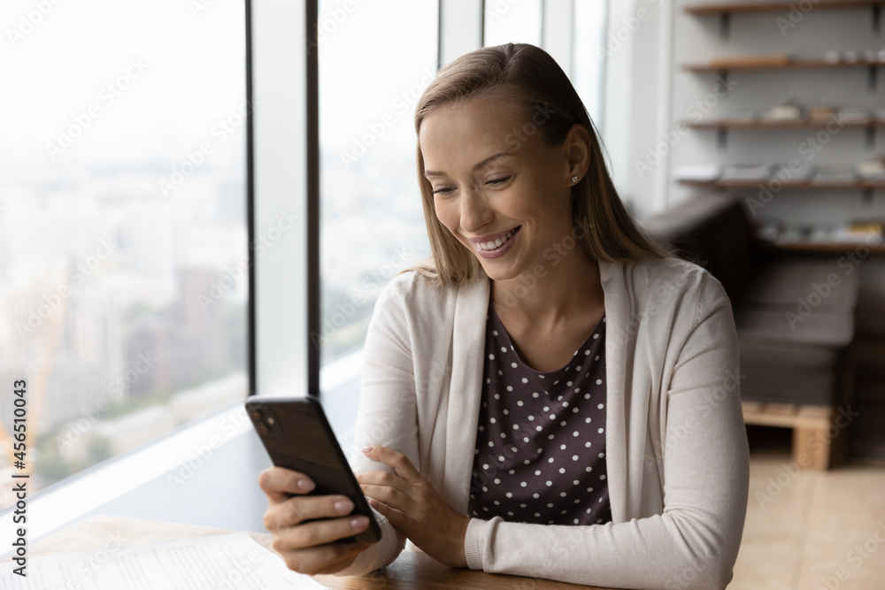 Happy young Caucasian woman use smartphone look at screen speak talk on video call online. Smiling millennial female have webcam virtual digital event on cellphone. Technology, communication concept. Happy young Caucasian woman use smartphone look at screen speak talk on video call online. Smiling millennial female have webcam virtual digital event on cellphone. Technology, communication concept.