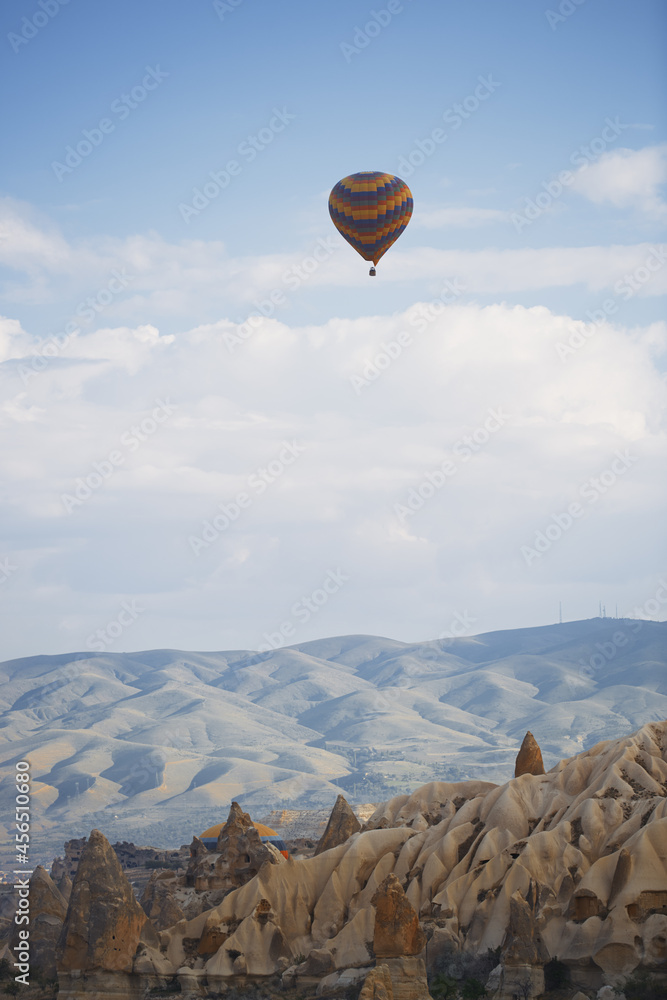 Hot air balloon flying over the rocky land